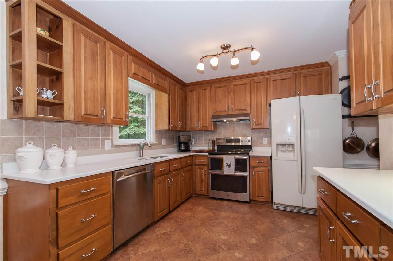1316 October Road Raleigh, NC 27614 - Photo 6 of 25 a kitchen with a sink stainless steel appliances and cabinets