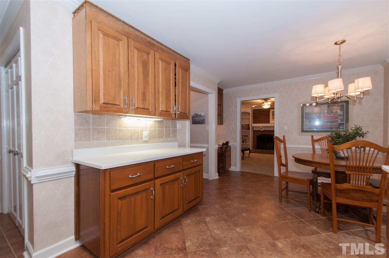 1316 October Road Raleigh, NC 27614 - Photo 7 of 25 a kitchen that has a lot of cabinets in it
