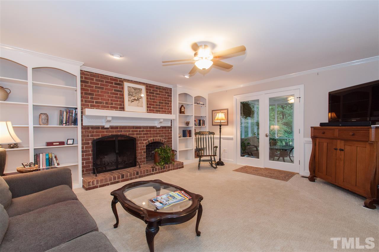 1316 October Road Raleigh, NC 27614 - Photo 9 of 25 a living room with furniture a flat screen tv and a fireplace