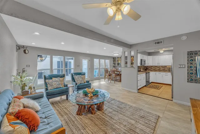 a living room with furniture and kitchen view