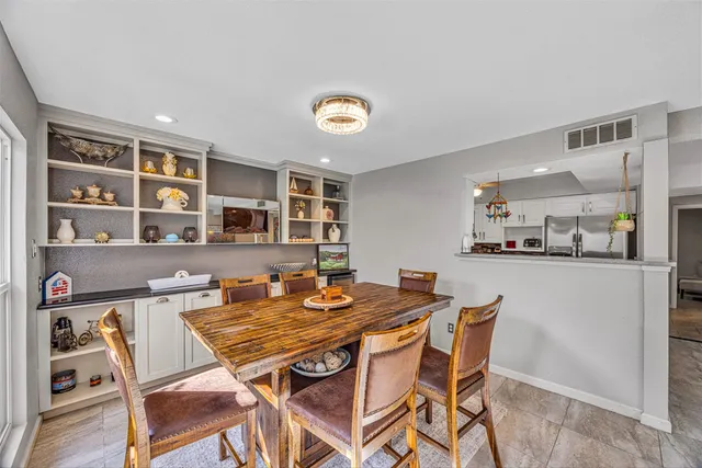 a dining room with a table and chairs