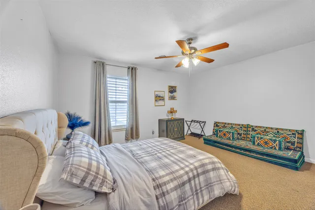 a bedroom with bed and window