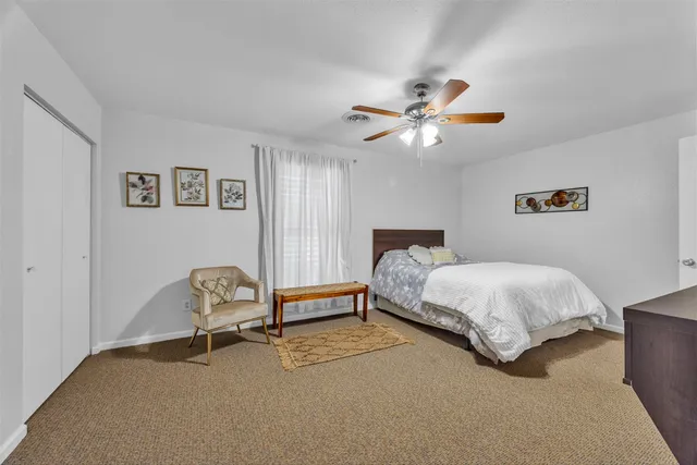 a bedroom with a bed chair and a chandelier