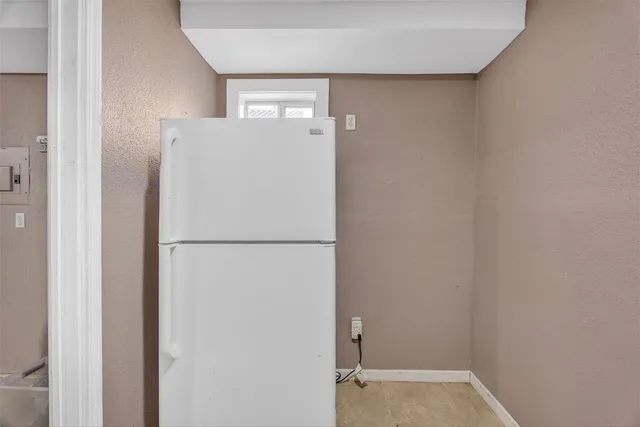 a backyard of a house with barbeque oven table and chairs