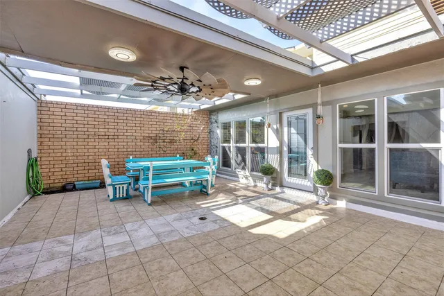 a backyard of a house with barbeque oven table and chairs