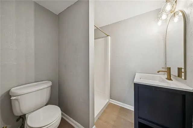 a white toilet sitting next to a bathroom sink