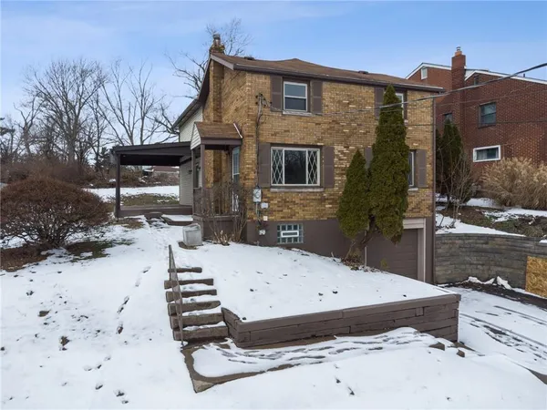 a view of a house with wooden fence