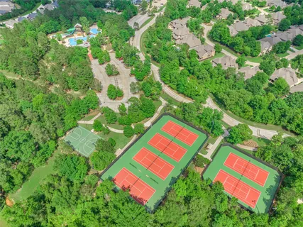 a aerial view of a house with a yard table and chairs