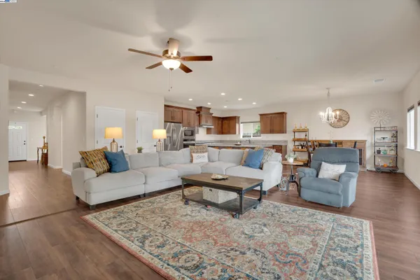 a living room with furniture and kitchen view