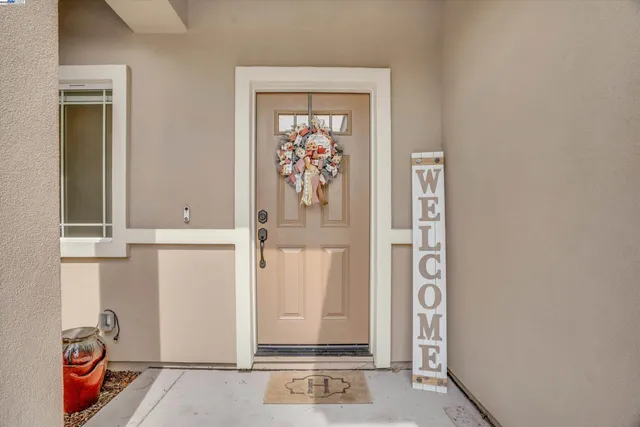 a view of a hallway with furniture and wooden floor