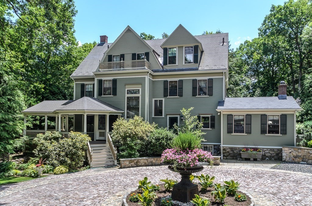 a front view of a house with plants and a yard