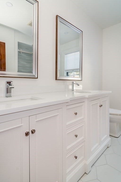 30 Cliff Road Wellesley, MA 02481 - Photo 16 of 30 a bathroom with double vanity sink two mirror and a window