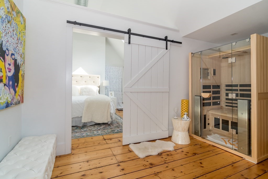30 Cliff Road Wellesley, MA 02481 - Photo 26 of 30 a view of a bedroom with wooden floor and furniture
