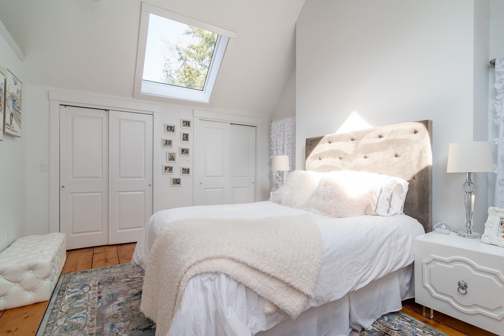 30 Cliff Road Wellesley, MA 02481 - Photo 27 of 30 a bedroom with a bed and wooden floor