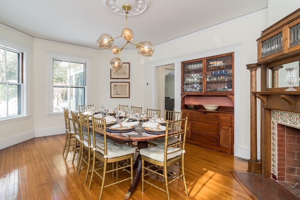 30 Cliff Road Wellesley, MA 02481 - Photo 7 of 30 a dining room with wooden floor a chandelier a wooden table and chairs