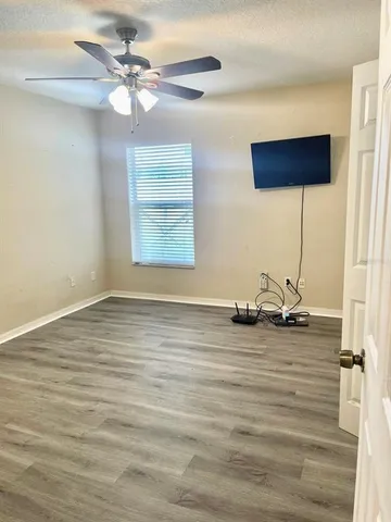 a view of a room with a window and ceiling fan