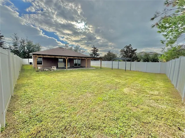 a view of a swimming pool with an outdoor seating and a yard
