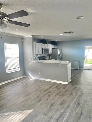 a view of kitchen with wooden floor and window