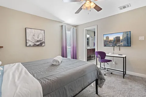 a en suite bathroom with a sink double vanity and a mirror