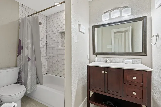 a bed room with a bed and a chair