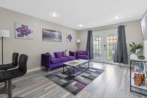 a living room with furniture and wooden floor