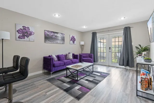 a living room with furniture and wooden floor