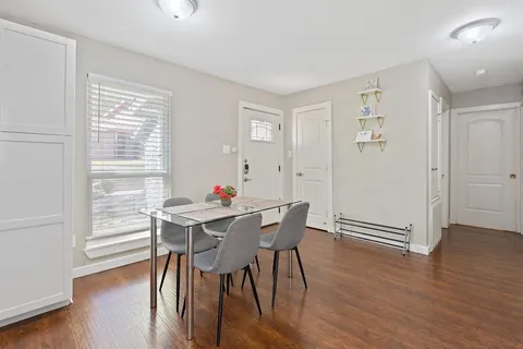 a view of a dining room with furniture and wooden floor