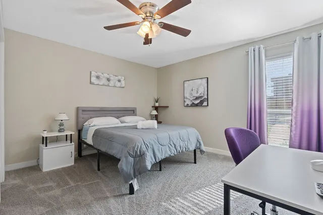 a bedroom with a bed and a chandelier