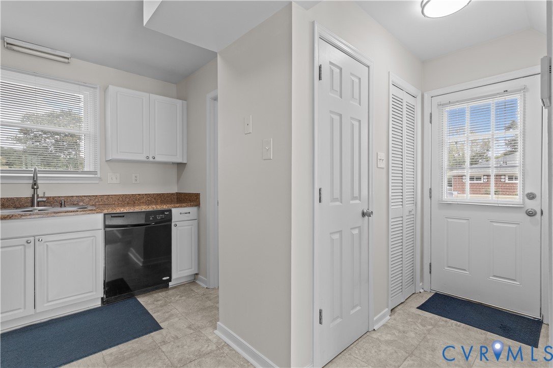 4801 Penick Road Richmond, VA 23228 - Photo 16 of 39 Kitchen featuring white cabinetry, plenty of natur