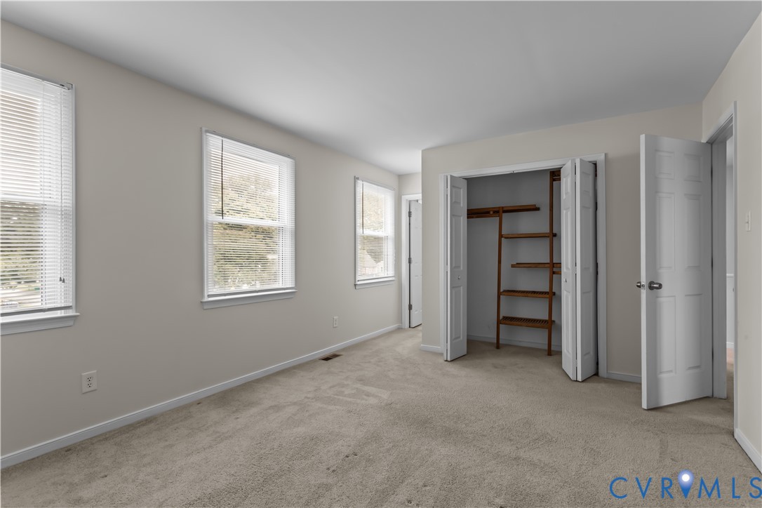 4801 Penick Road Richmond, VA 23228 - Photo 21 of 39 Primary bedroom featuring light colored carpet and