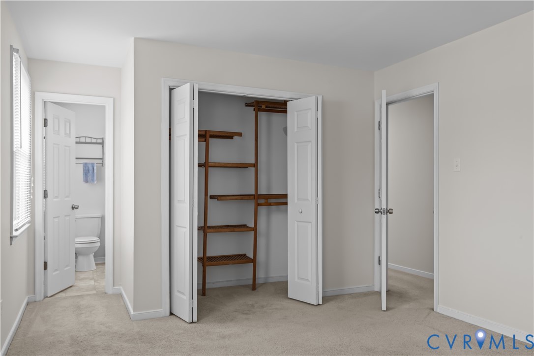 4801 Penick Road Richmond, VA 23228 - Photo 23 of 39 Primary bedroom featuring light carpet, a closet,