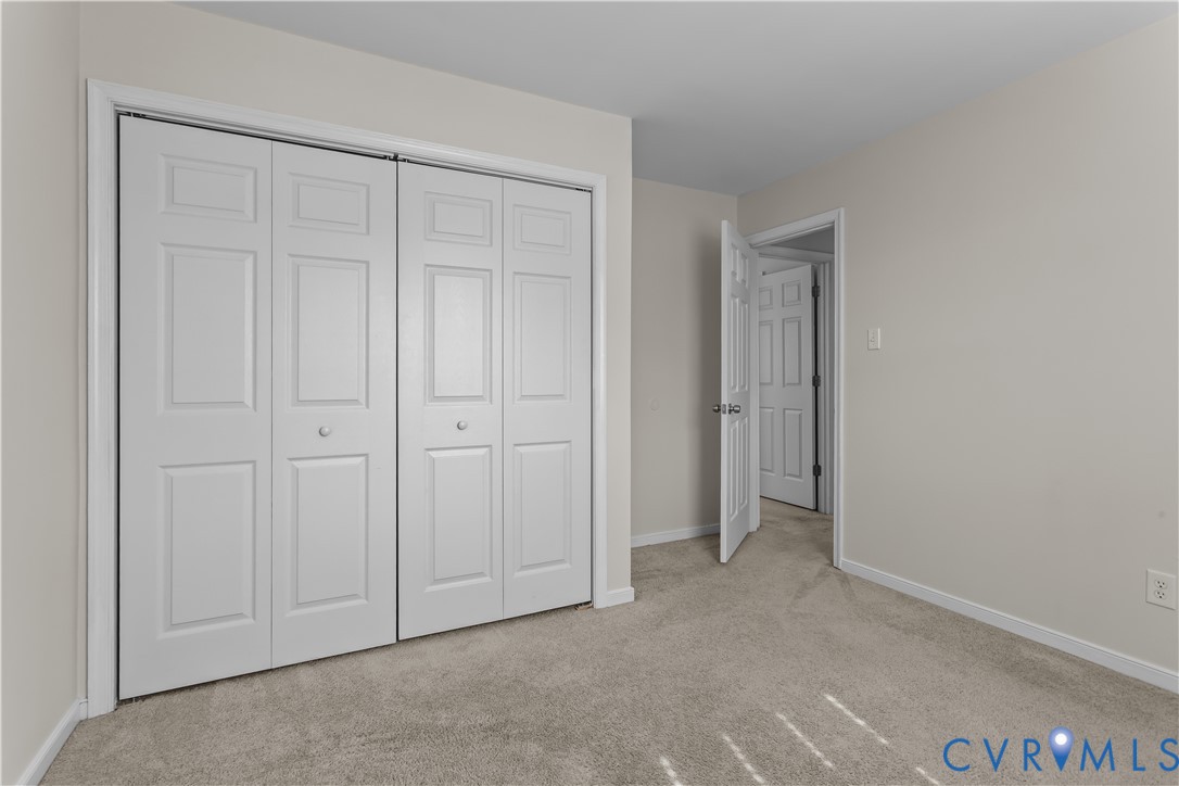 4801 Penick Road Richmond, VA 23228 - Photo 27 of 39 Bedroom with light colored carpet and a closet