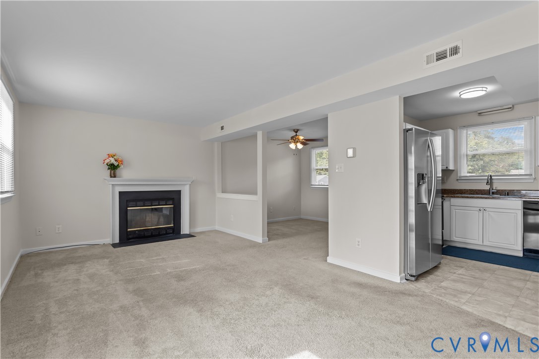 4801 Penick Road Richmond, VA 23228 - Photo 5 of 39 Living room with a ceiling fan, light carpet, and