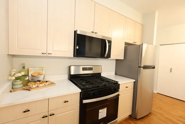 a kitchen with granite countertop a stove and a refrigerator