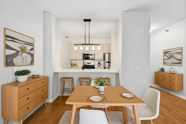 a view of kitchen with cabinets table and chairs
