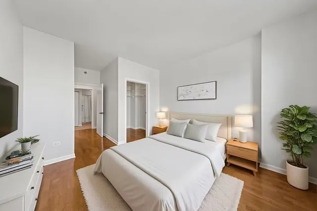 a bedroom with a bed and a flat screen tv