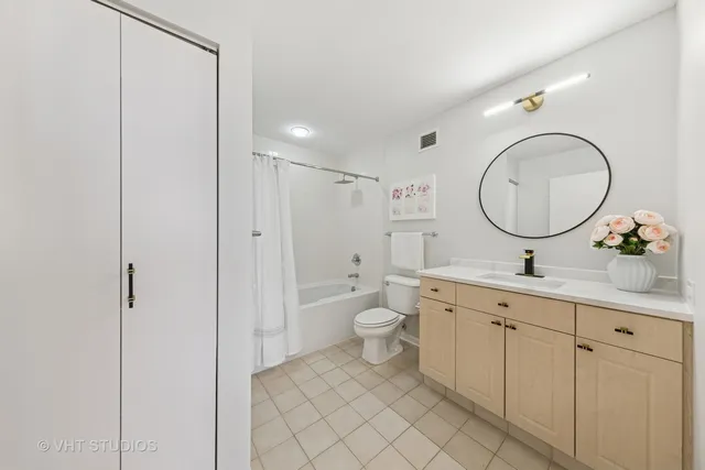 a bathroom with a double vanity sink mirror and toilet