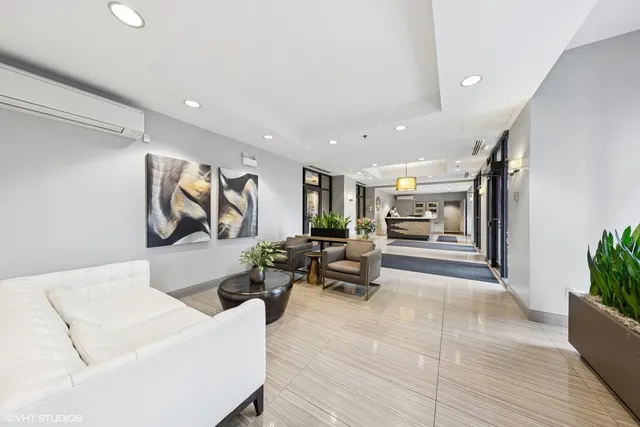 a living room with furniture and a potted plant