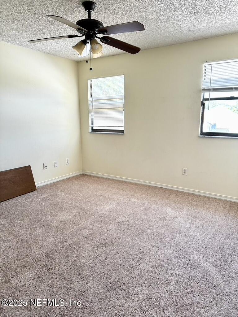 11368 Canvasback Court Jacksonville, FL 32225 - Photo 16 of 19 a view of a room with a ceiling fan and window