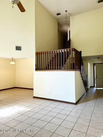 a view of an empty room with a fireplace and a window