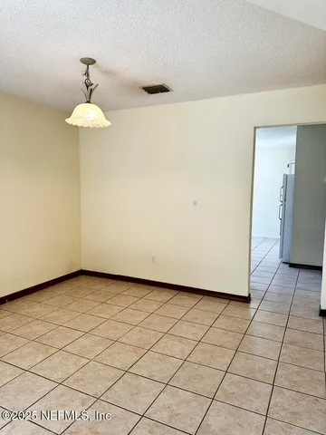 a view of a room with a large window and chandelier
