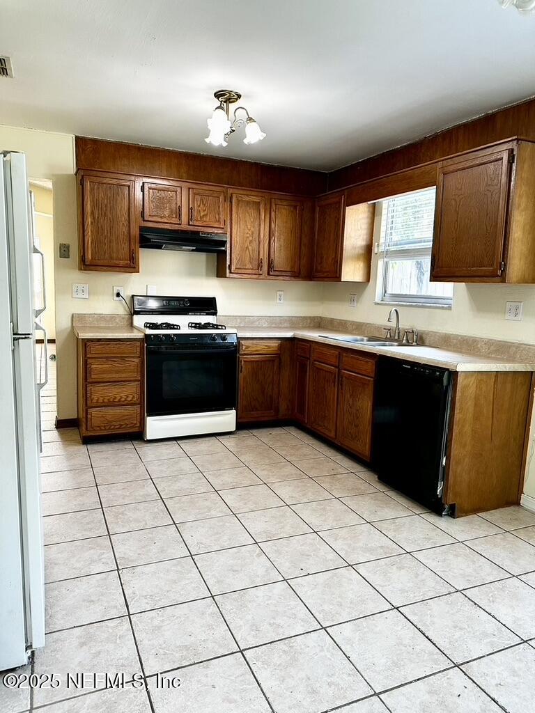 11368 Canvasback Court Jacksonville, FL 32225 - Photo 8 of 19 a large kitchen with stainless steel appliances granite countertop a sink and cabinets