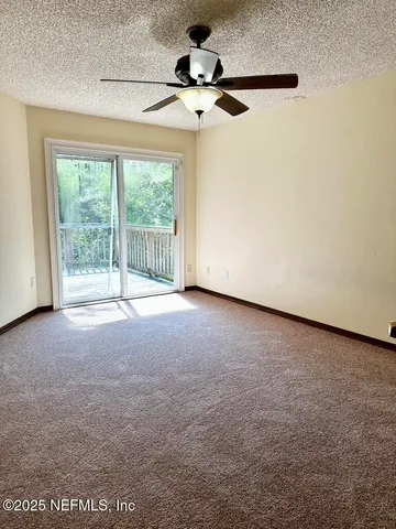 a view of a room with a ceiling fan