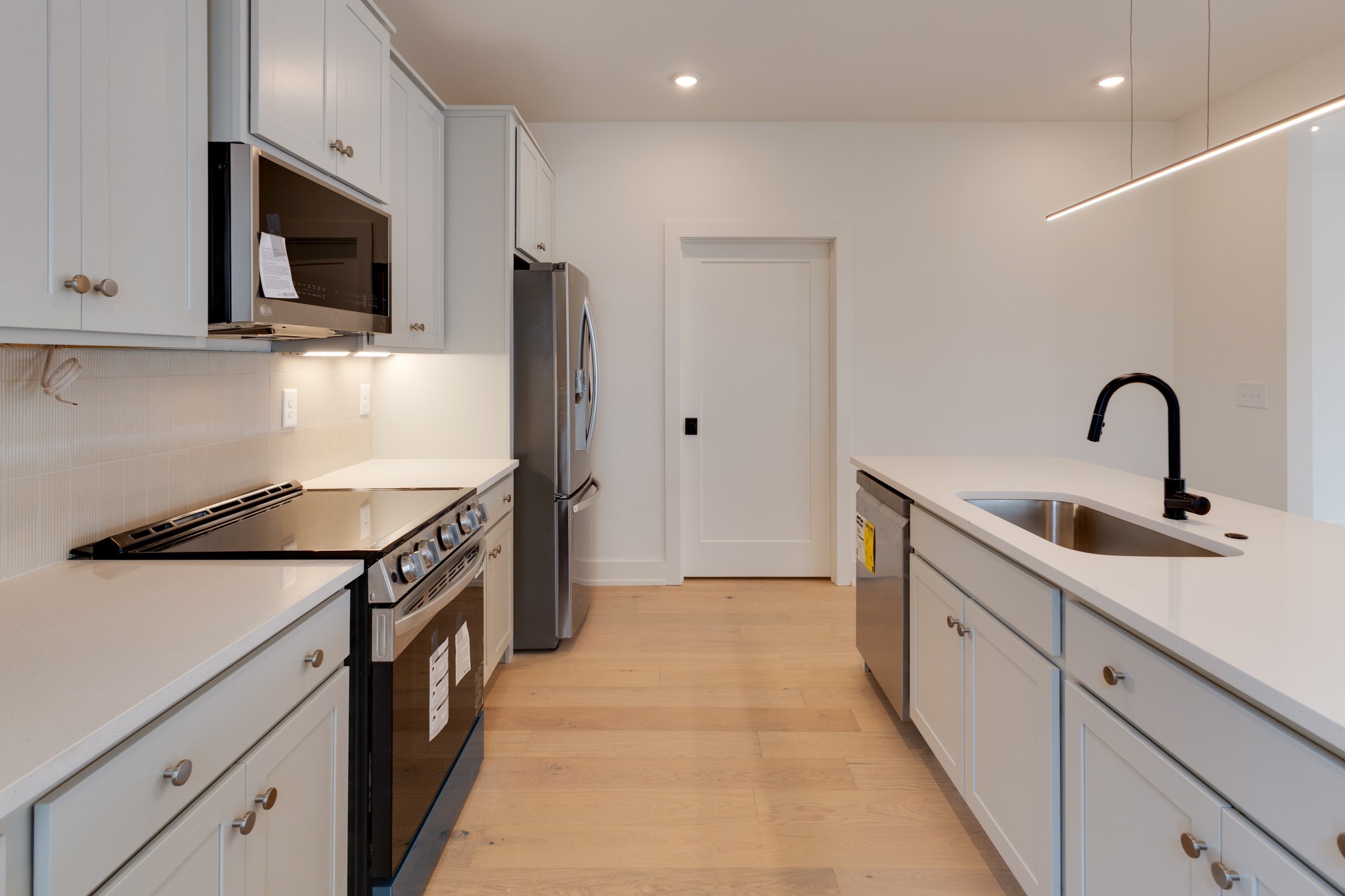 533 Midnight Way Nashville, TN 37209 - Photo 13 of 42 a kitchen with stainless steel appliances granite countertop a sink a stove and a refrigerator