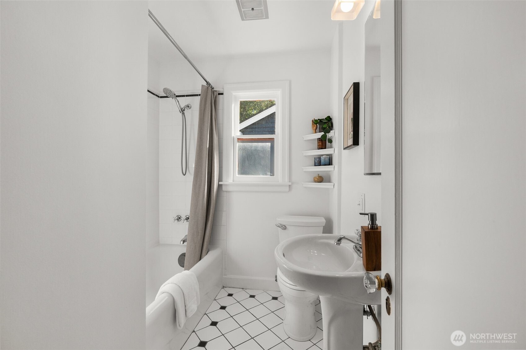 8606 29th Avenue Northwest Seattle, WA 98117 - Photo 11 of 33 a bathroom with a sink toilet and shower