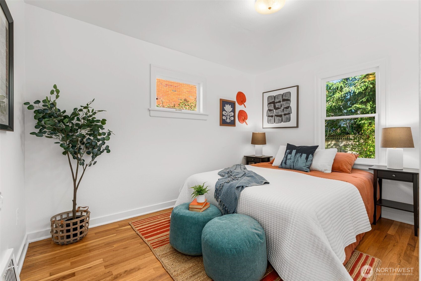 8606 29th Avenue Northwest Seattle, WA 98117 - Photo 14 of 33 a bed room with a bed and a potted plant