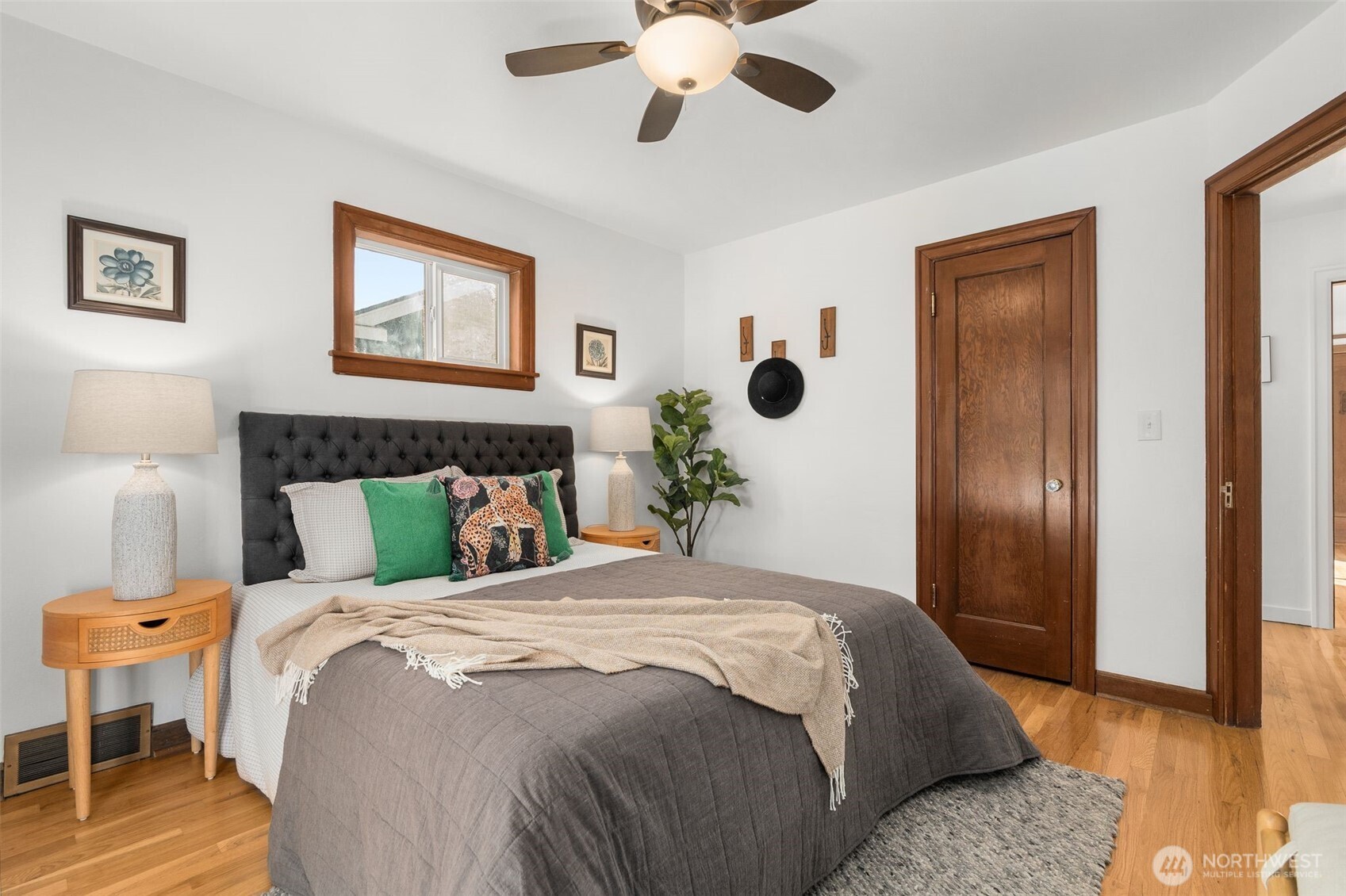 8606 29th Avenue Northwest Seattle, WA 98117 - Photo 15 of 33 a bedroom with a bed and a chandelier