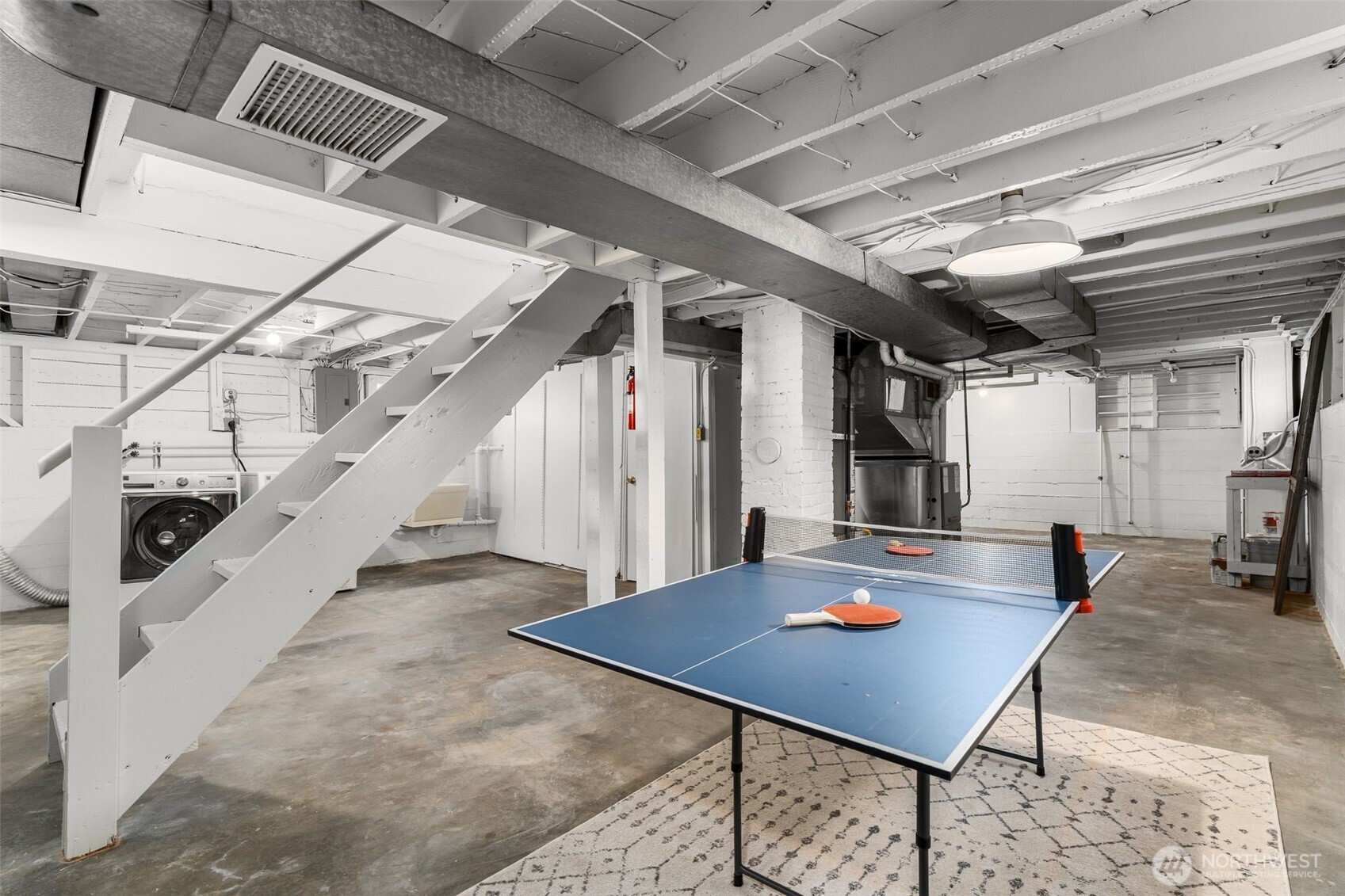 8606 29th Avenue Northwest Seattle, WA 98117 - Photo 17 of 33 a living room with lots of furniture and a table