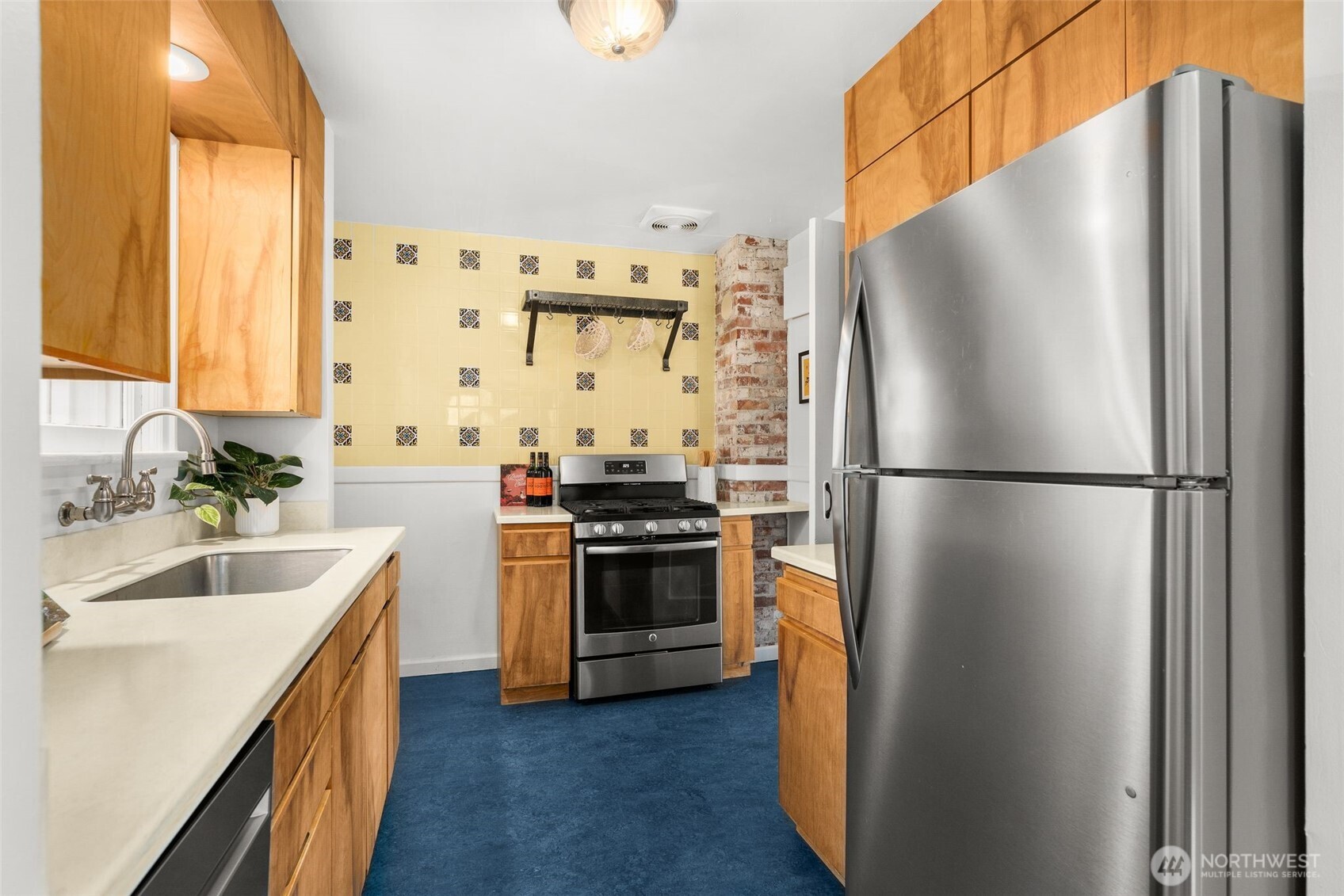 8606 29th Avenue Northwest Seattle, WA 98117 - Photo 8 of 33 a kitchen with a refrigerator sink and stove