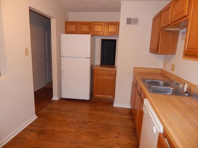 1347 Springlawn Court Raleigh, NC 27609 - Photo 4 of 8 a kitchen with a refrigerator sink and stove